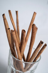 cinnamon stick in a glass on white background