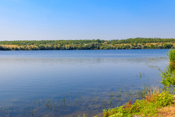 Summer landscape with beautiful river, green trees and blue sky
