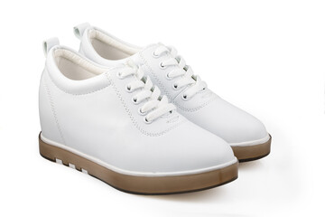 White women's sports shoes made of leather isolated on a white background. Minimal concept of beauty and sports. The white women's sneakers isolated on white.