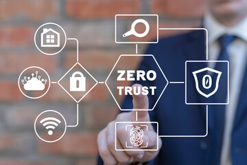 Businessman using virtual touch screen presses inscription: ZERO TRUST. Concept of zero trust...
