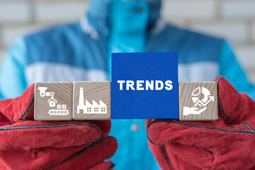 Worker holding colorful blocks and sees word: TRENDS. Trendy manufacturing diagram. Industry trend...