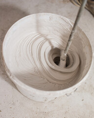 Mixing putty in a bucket with a mixer - wall finishing © andrey gonchar