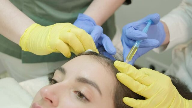 Plasma therapy of the scalp. Hair mesotherapy procedure in the modern cosmetology clinic