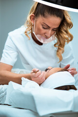 Woman eye with long eyelashes. Beautiful young woman during eyebrows drawing.