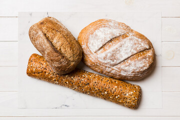 Homemade natural breads. Different kinds of fresh bread as background, top view with copy space