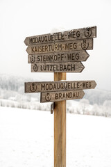 Neunkircher Hoehe hiking direction sign made of wood during winter