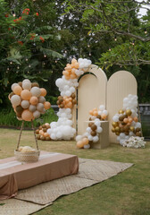 Creative gender neutral baby shower or birthday decoration in the garden. Bohemian style outdoor...