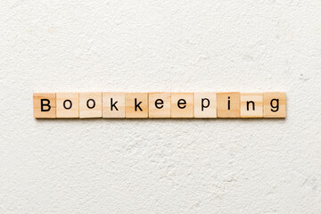 bookkeeping word written on wood block. bookkeeping text on table, concept
