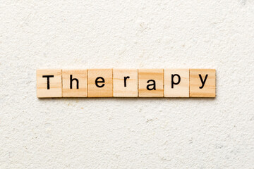 therapy word written on wood block. therapy text on cement table for your desing, concept