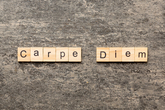 Carpe diem word written on wood block. Carpe diem text on table, concept