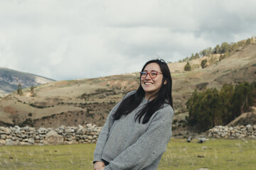 Naklejka premium Portrait of woman enjoying her vacation in a mountain landscape in the Andes Mountains in South America. Concept of people, travel and vacation.