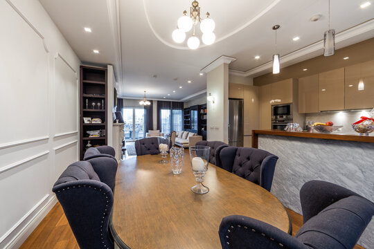 Dining table with chairs in luxury open plan apartment