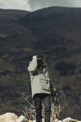Portrait of a tourist enjoying his vacation in a mountain landscape in the Andes Mountains (South America). Concept professions, people, travel and vacations.