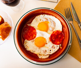 Spanish tapas with chorizo sausage and tomato paste close up