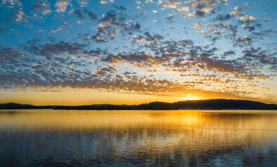 Pretty sunrise waterscape with low clouds - obrazy, fototapety, plakaty