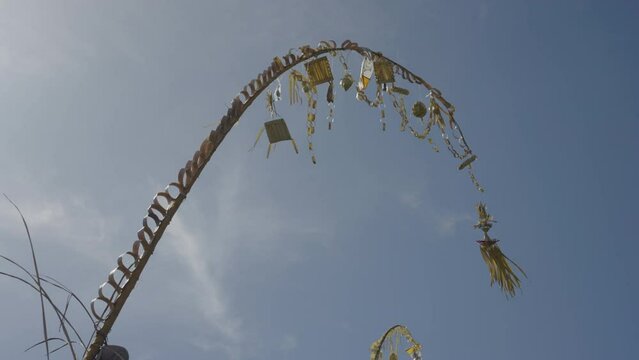 Low Angle View Of Penjor Waving In Wind On Sunny Day - Bali, Indonesia
