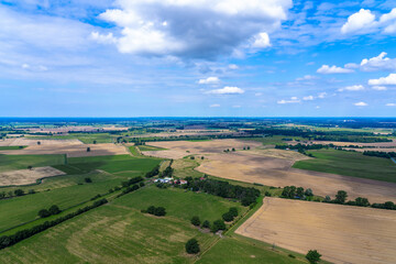 Fototapeta na wymiar Aerial view of green meadows and yellow fields in Lower Saxony