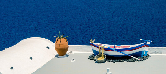 Wooden boat on a house terrace in Santorini