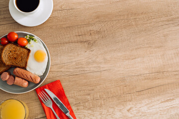 English breakfast with black coffee and orange juice on the wooden table with copy space