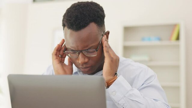 Stress, headache and professional black man in the office with a project or work deadline. Migraine, frustration and African male business employee with burnout while working on computer in workplace