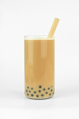 homemade chocolate coffee milk bubble tea with tapioca pearls in a glass with bamboo straw