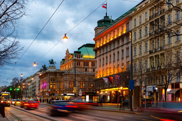View of Opernring and Vienna State Opera building in evening. Section of Ringstrasse.