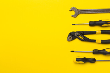 Set of tools on color background, top view