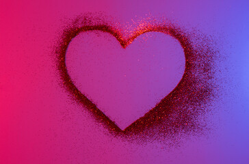 Heart of red bright sparkles in neon light. Shiny heart on a shiny background. Artistic design colorful and shiny bright background for holidays.
