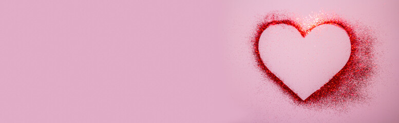 Heart of red bright sparkles on a pink background. Brilliant, sparkling heart for Valentine's Day.Beautiful holiday Template for design greeting card, flyer, billboard or Web banner