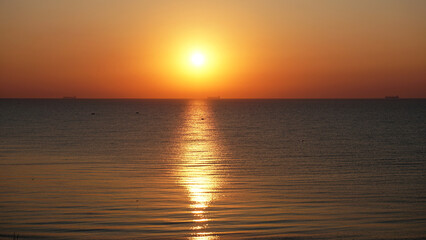 Bright orange sunrise over the sea clear sky view