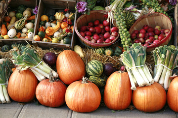 Pumpkins with vegetables and fruit at farmer's market.