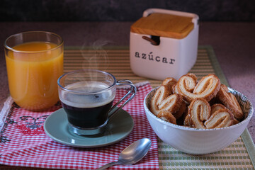 Breakfast with puff pastry glasses coffee and orange juice on dark background