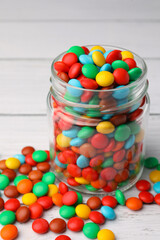 Tasty colorful candies on white wooden table, closeup