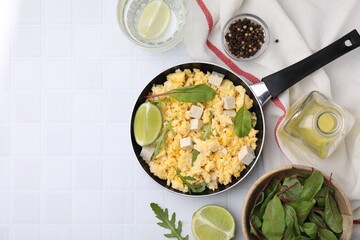 Delicious scrambled eggs with tofu and ingredients on white table, flat lay. Space for text