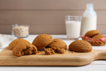 Delicious oatmeal cookies on white wooden table