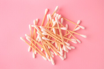 Heap of clean cotton buds on pink background, flat lay