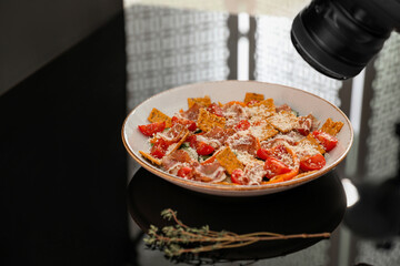Composition of salad with prosciutto in photo studio. Food photography