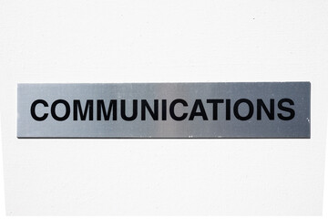 Communication text signage on a silver background