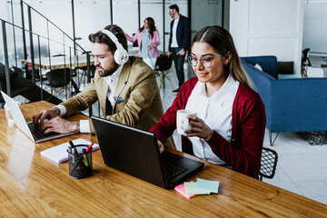 young hispanic couple woman and man at work using computer in casual clothes at office in Mexico...