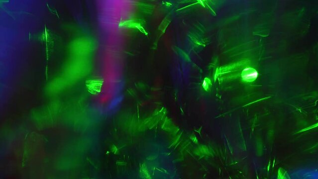 Light leaks effect background abstract animation. Green and neon blue lights sparkle through shiny crystal and prism. Lens light leaks flashing