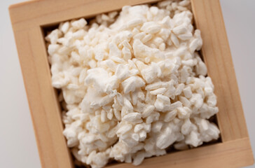 Rice koji in a box placed on a white background. Koji mold. Koji is fermented rice.