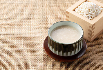 Amazake and rice malt in a Masu box on the table.