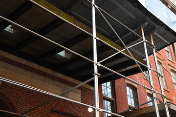 metal-wood scaffolding on the facade of an apartment building