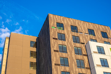 Modern apartment buildings on a sunny day with a blue sky. Facade of a modern apartment building. New apartment building