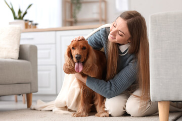 Young woman with red cocker spaniel and plaid in kitchen