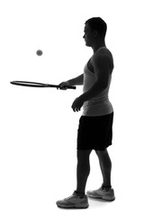 Silhouette of young man playing tennis on white background