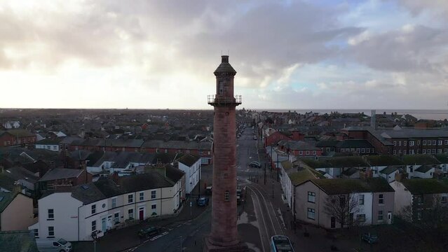 Inland lighthouse amongst urban setting at the port of Fleetwood with tram leaving