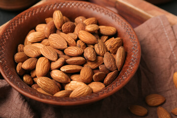 Plate of almond nuts on table, closeup