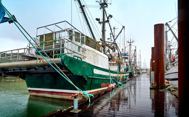 Fototapeta na wymiar Fishing boats in Steveston harbor. Waterfront Steveston Fisherman's Wharf. Richmond, BC, Canada