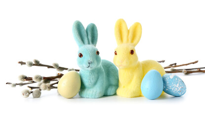 Easter bunnies, eggs and willow branches on white background